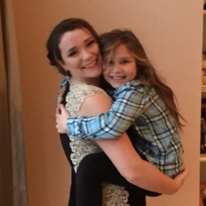 Floor length black dress with lace sides.